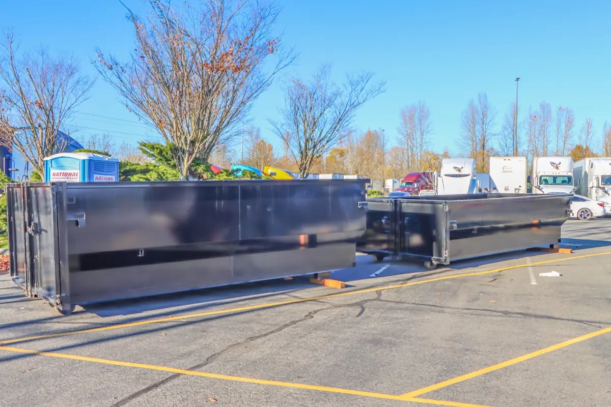 Professional dumpster rental service with roll-off container on residential driveway in Ottawa